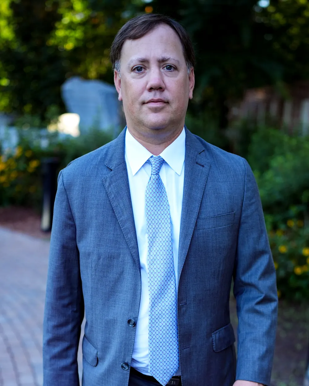James E. Brogdon III, founder of Brogdon Law Group, outdoors at golden hour
